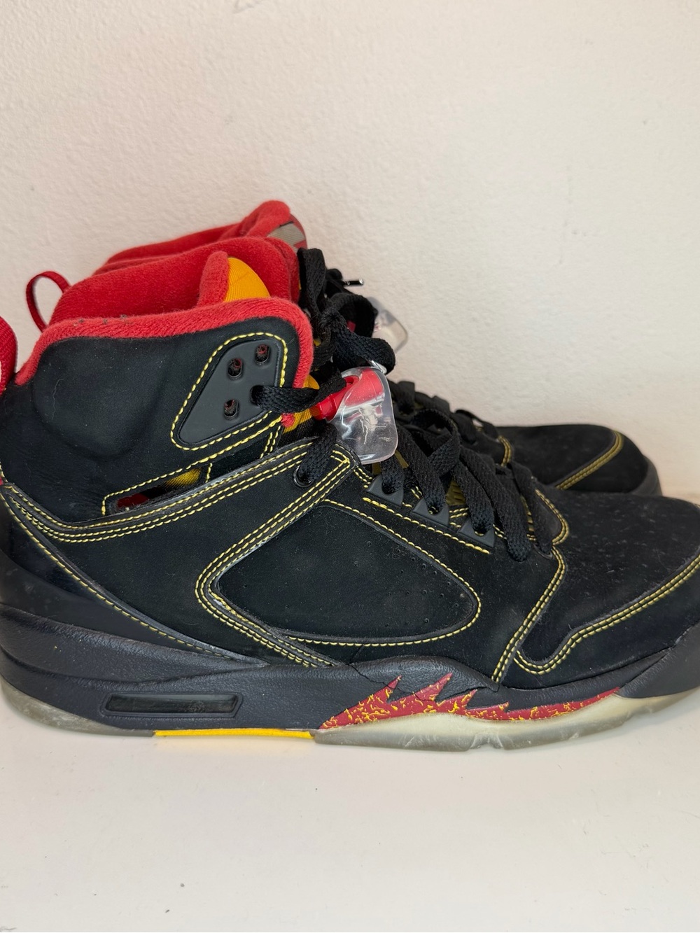 Jordan Men's Black High-Top Sneakers with Red and Yellow Accents